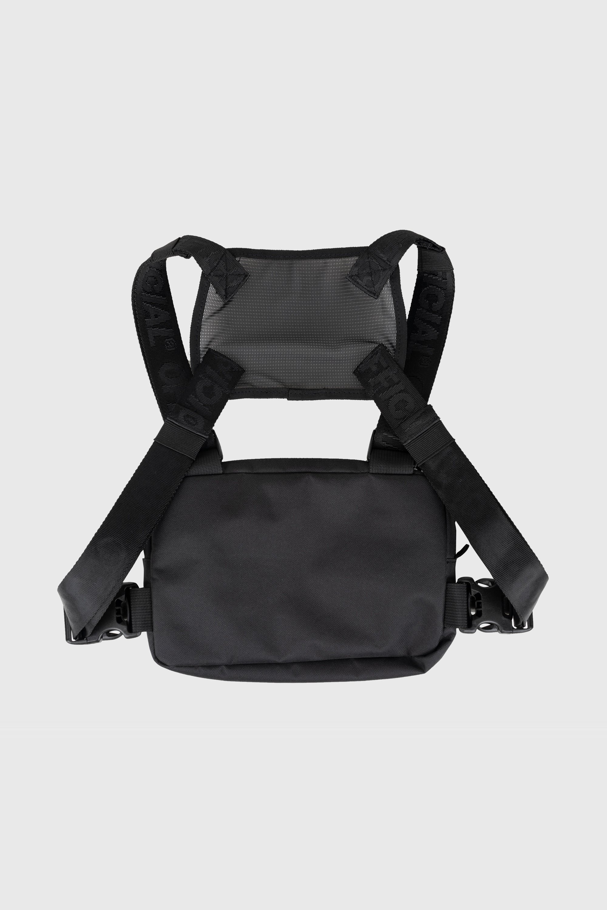 Compact Essential Chest Bag in black back view on person. Mesh panel connecting the four straps.